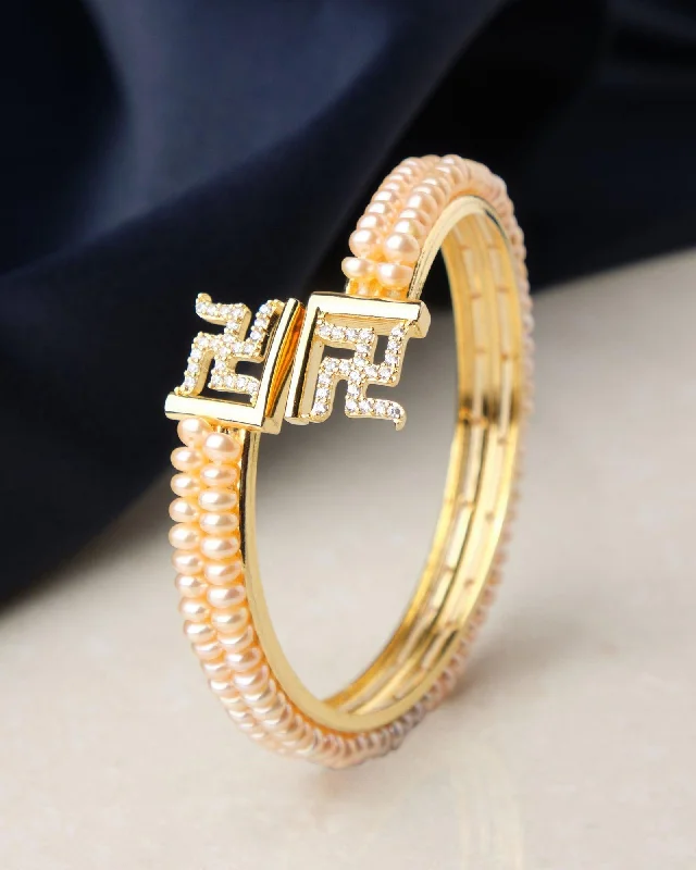 Custom gemstone bangles for unique personal style-Swastik Stone Studded Pearl Bangle