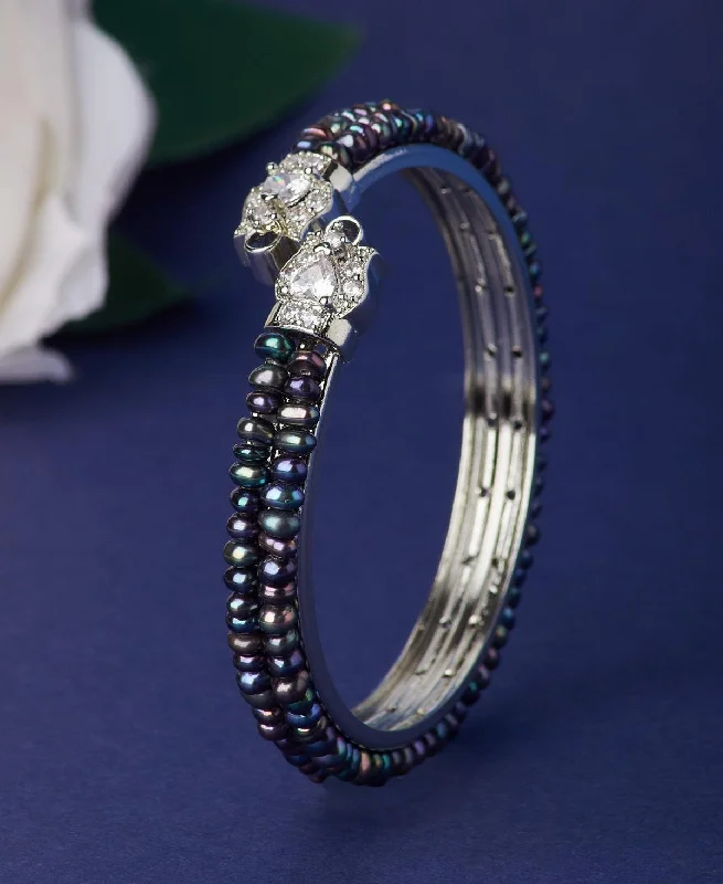 Bangles with floral accents for a feminine touch-Stunning Stone Studded Pearl Bangle