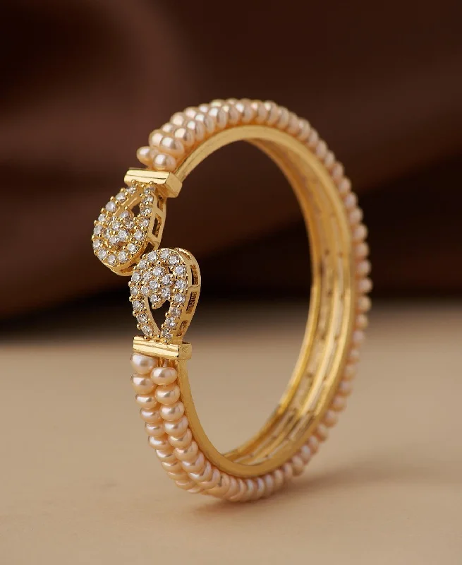 Slim gold bangles for a delicate look-Stunning Stone Studded Pearl Bangle